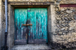 Old wooden gate in turquoise in Ille sur Têt Old wooden gate in turquoise in Ille sur Têt